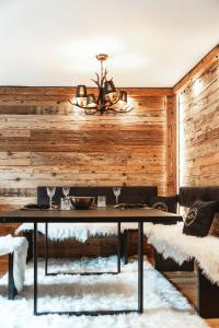 a dining room with a table and a chandelier at StAnton Snow in Sankt Anton am Arlberg