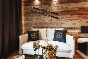 a living room with a white couch with pillows at StAnton Snow in Sankt Anton am Arlberg
