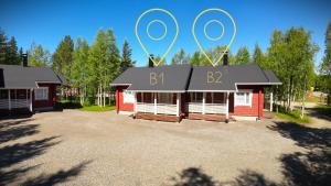 a building with a sign on top of it at Lumilyhty B in Äkäslompolo
