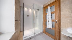 a bathroom with a shower and a glass door at Ennios Boutique Hotel in Southampton +44 photos