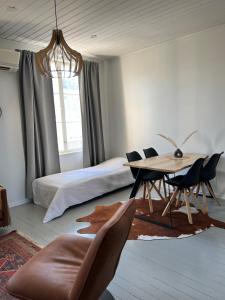 a bedroom with a bed and a table and chairs at Unique & premium apartment with free wifi & parking for 2 cars in the center of Kerava in Kerava