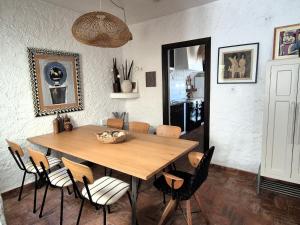 a dining room with a wooden table and chairs at Casita Pablo in Agua Amarga
