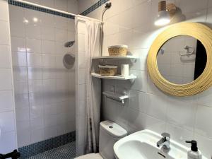 a bathroom with a sink and a mirror and a toilet at Casita Pablo in Agua Amarga +13 photos