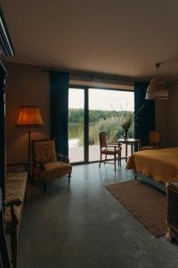 a bedroom with a bed and a table and chairs at ArtFolwark Wojnowo in Wojnówko +87 photos