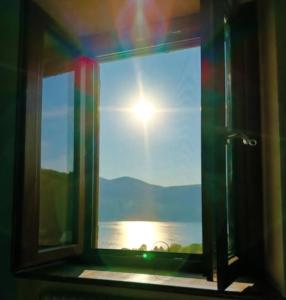 a window in a bathroom with a view of the water at La Dimora del Turano in Castel di Tora