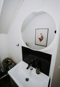 a bathroom with a sink and a mirror at KOHT apartment in Pärnu +82 photos