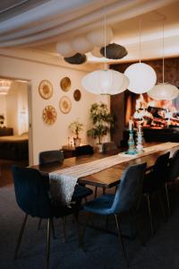 a dining room with a wooden table and chairs at KOHT apartment in Pärnu