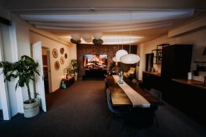 a living room with a long table and a couch at KOHT apartment in Pärnu