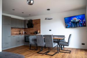 a kitchen and dining room with a table and chairs at Moderne Ferienwohnung nahe Salzburg & Eugendorf in Eugendorf