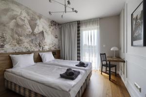 a bedroom with two beds with towels on them at Osada Hipodrom in Łąck +80 photos
