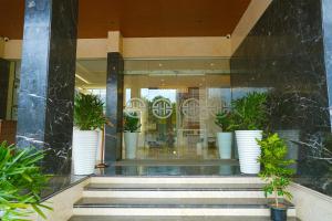 a store front with a bunch of potted plants at Highland Hotel in Bangalore