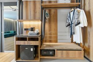 a room with a bunk bed and a tv at The Everly Lhesson Kuching in Kuching