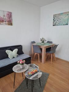 a living room with a couch and a table at Happiness Apartment Skopje in Skopje