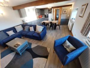 a living room with a blue couch and a table at The Old Stone Barn in Warrington
