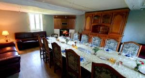 a dining room with a long table with chairs at La Grande Vesvre in Gigny