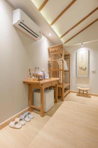 a room with a vanity and a table with slippers at Chang'E Villa Rakthai in Ban Rak Thai +41 photos