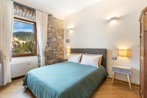a bedroom with a large bed and a window at Bosa Eye House 1873 in Bosa