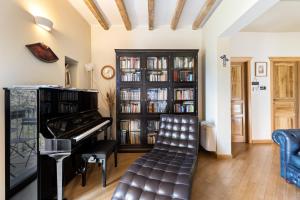 a living room with a piano and a book shelf at Bosa Eye House 1873 in Bosa +46 photos