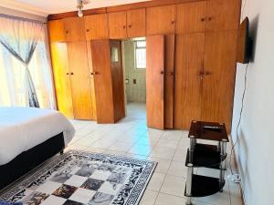 a bedroom with a bed and a television in it at Zahies Accommodation in Panorama