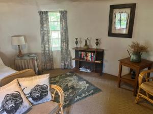a living room with a couch and a table at Baldinnie Cottages in Nottingham Road