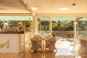 a patio with chairs and a table on a porch at Hotel Sierra Silvana in Selva di Fasano