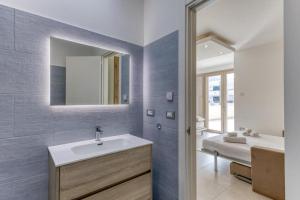 a bathroom with a sink and a mirror at La Spiaggetta 2 in Torre San Giovanni Ugento +42 photos