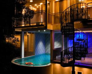 a building with a swimming pool in the middle at La Paraiso by WhiteTrip in Vagamon
