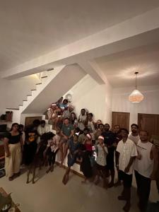 a group of people posing for a picture in a room at Dreamers Surf House in Matara