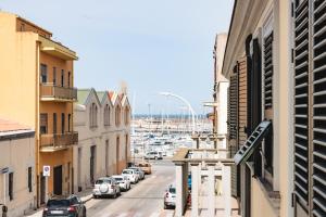 a city street with cars parked in a parking lot at City Boutique in Porto Torres