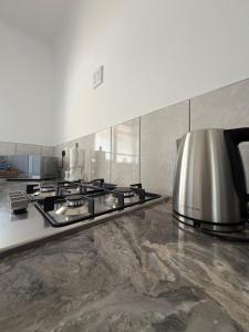 a kitchen with a stove and a toaster at Plattekloof Mountain view in Plattekloof +20 photos