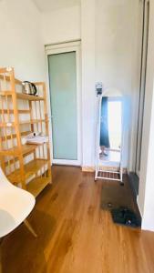 a room with a mirror and a wooden floor at Kavy Homestay in Thôn Trường Giang