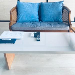 a couch with two remote controls on a coffee table at 福のや in Unnan