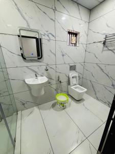 a white bathroom with a sink and a toilet at MIRACLE Inn in Alwaye +22 photos