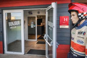 a statue of a firefighter standing outside of a building at Enzo Hotels Chartres Mainvilliers in Chartres