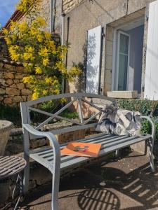 a bench in front of a building with a window at Gîte à la campagne "Le Luquet" in Chazelles