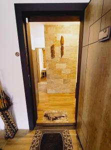 a hallway leading to a room with a stone wall at Студио Странджа - Граматиково in Gramatikovo
