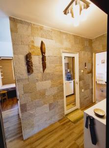 a stone wall in a living room with a counter at Студио Странджа - Граматиково in Gramatikovo