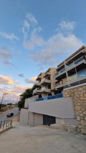 a building in front of a parking lot at 3 Keys Luxury Apartment in Nikiana