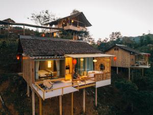 an aerial view of a house with a balcony at Chang'E Villa Rakthai in Ban Rak Thai