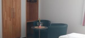 a room with two chairs and a table with two glasses at BBZ Burg Weißensee in Weißensee