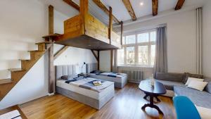a living room with a couch and a staircase at Old Town Loft in Žilina