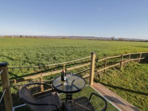 a table with two chairs and a bottle of wine at GiGi's Horsebox in Evesham +6 photos