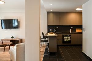 a kitchen and living room with a couch and a table at Thessaloniki Central Luxe in Thessaloniki