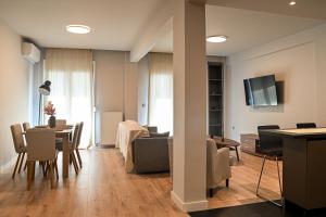 a living room with a couch and a table at Thessaloniki Central Luxe in Thessaloniki