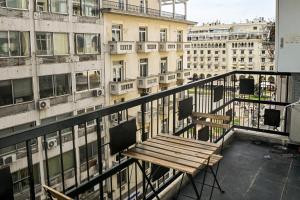 a wooden bench on the balcony of a building at Thessaloniki Central Luxe in Thessaloniki