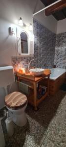a bathroom with a sink and a toilet and a tub at Napsugár Vendégház Nagylóc in Nagylóc +89 photos