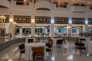 a restaurant with tables and chairs in a building at Iconic Plaza Hotel in Nairobi