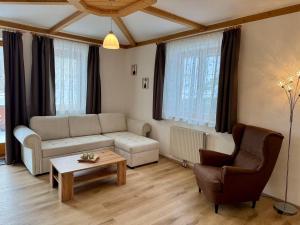 a living room with a couch and a coffee table at Ferienhaus am Bauernhof mit Terrasse nähe Wexl Arena in Sankt Corona am Wechsel +28 photos