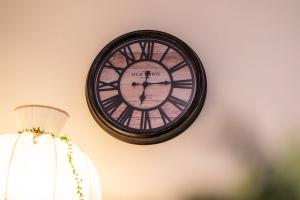 a clock hanging on a wall next to a lamp at GuestReady - Varanda de belas lembranças in Funchal