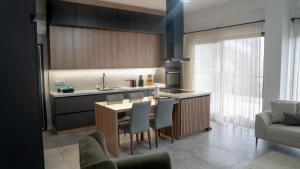 a kitchen with a table and chairs and a kitchen with a couch at View Guest House in Geyikbayırı